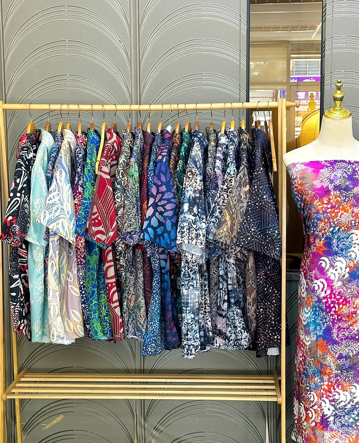 A selection of cotton batik shirts on a rack